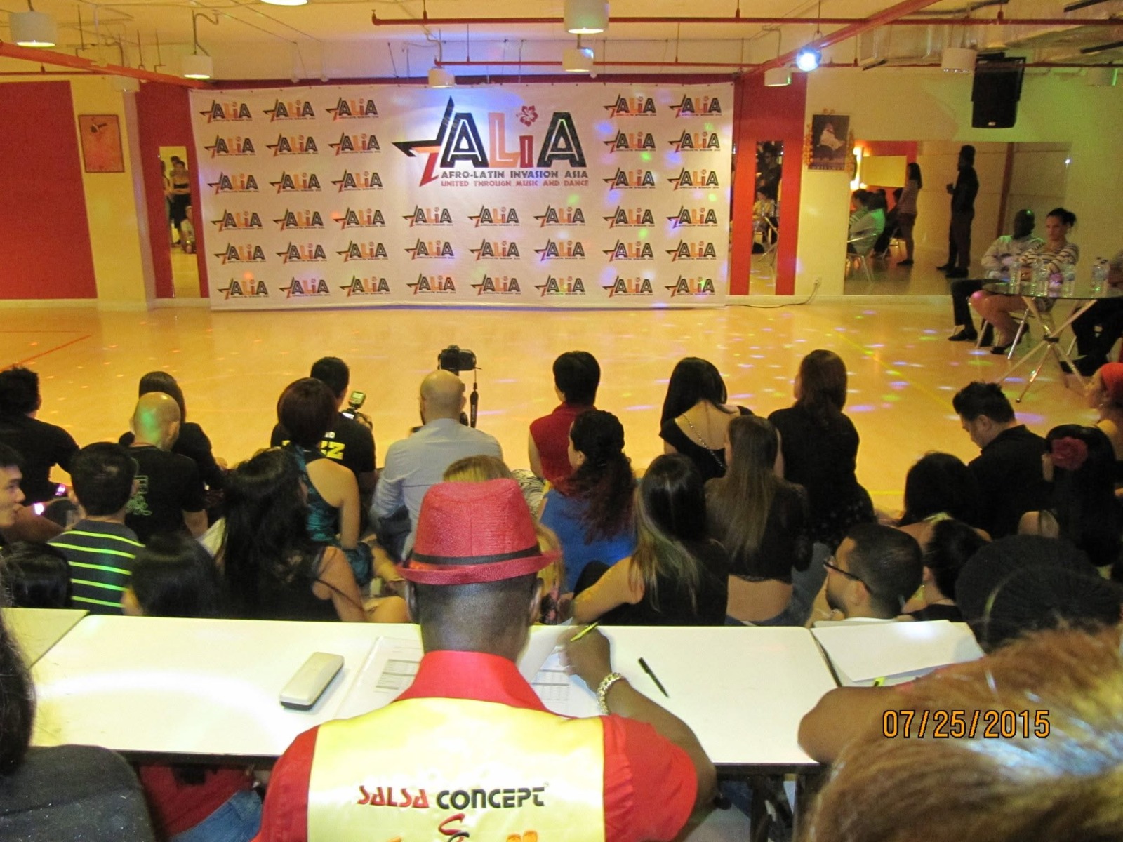 Guests and performers gathered in front of the ALIA backdrop during the ALIA festival.