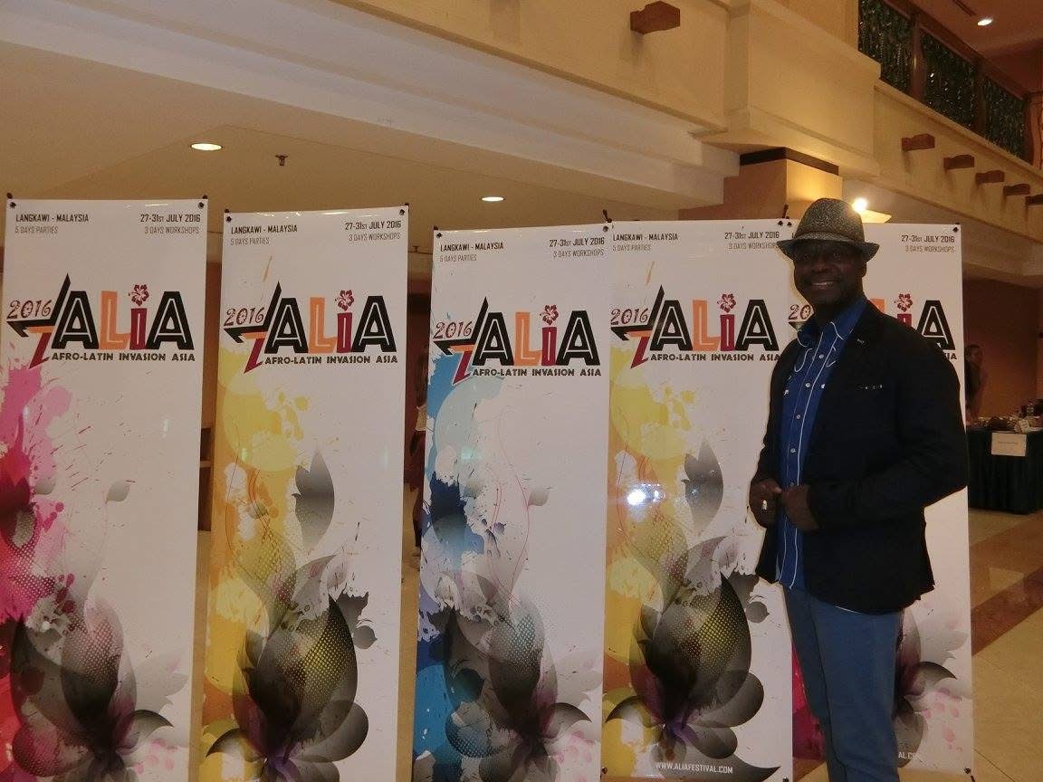 Dr. Salsa beside the ALIA 2016 (Afro-Latin Invasion Asia) banners in Langkawi, Malaysia.