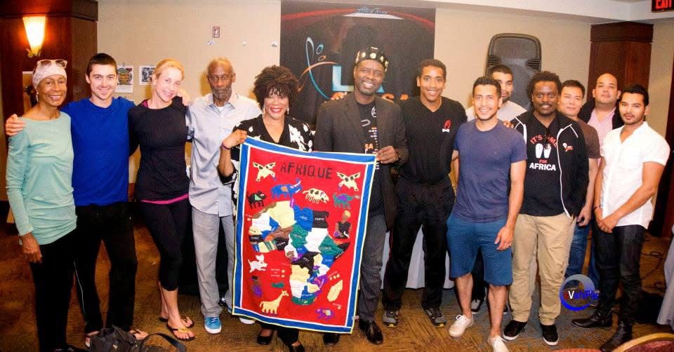 Dr. Salsa with seminar participants holding an African textile at the 2014 Los Angeles Salsa Fest.